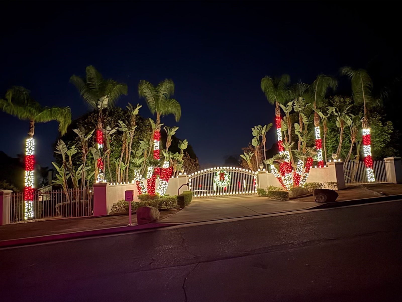 Red and white palm wraps at an estate gate