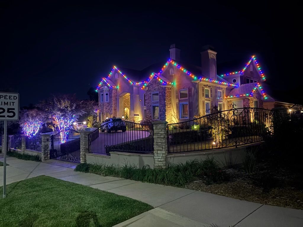 Multicolor roofline across the gables of a stone-and-stucco estate